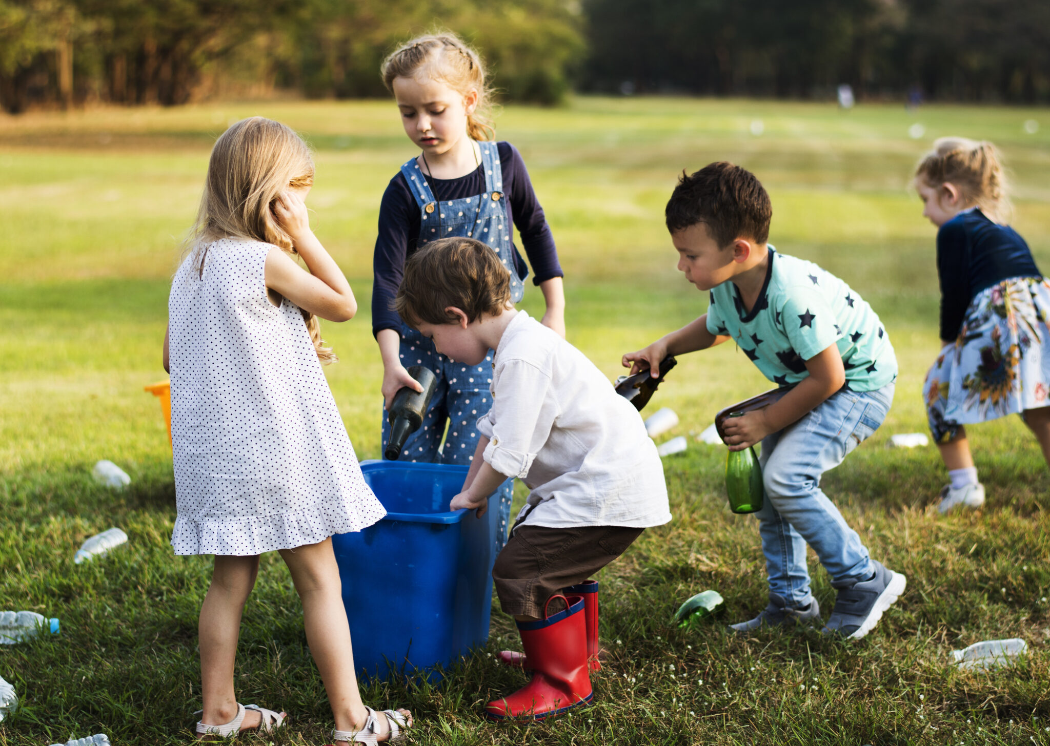 Four children playing together outdoors on a sunny day.