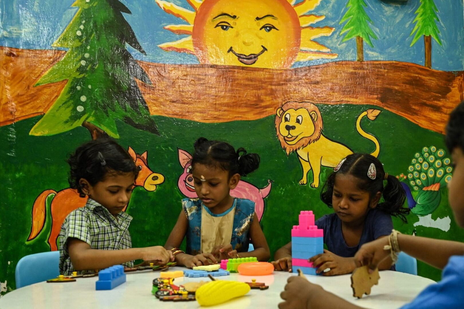 Children playing with toys in colorful mural