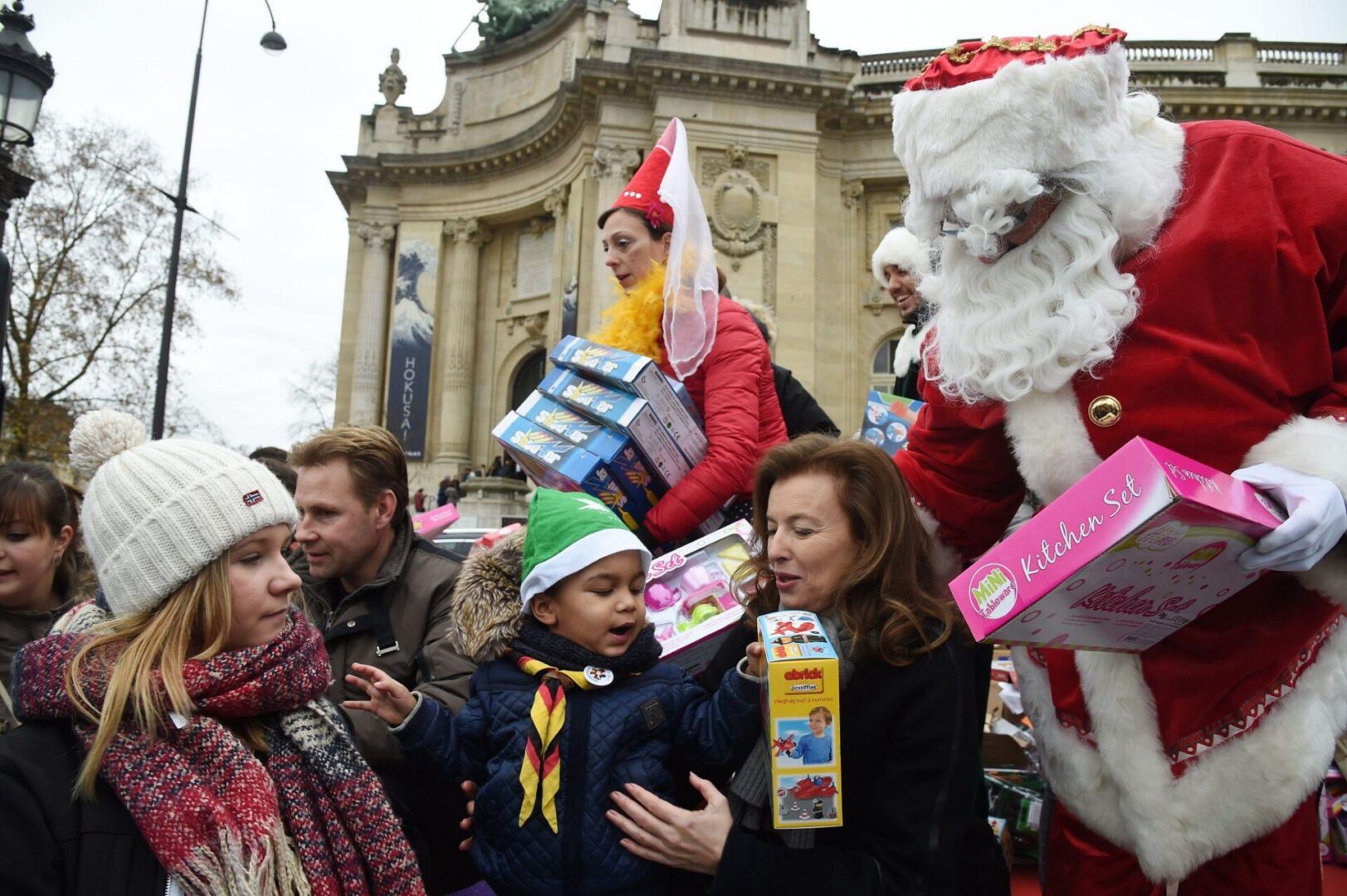 Santa giving gifts to children outdoors