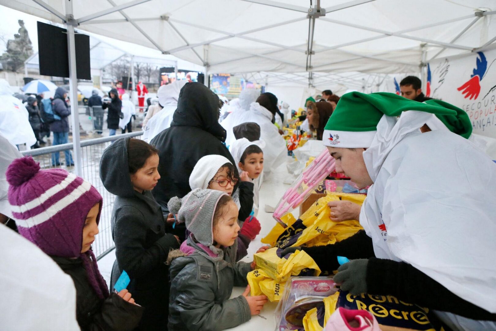 Volunteer handing out toys to children